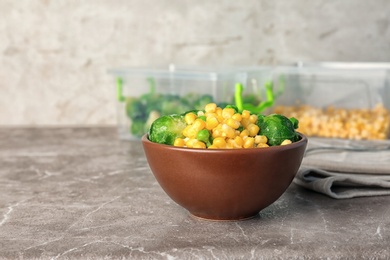 Photo of Bowl with different frozen vegetables on table