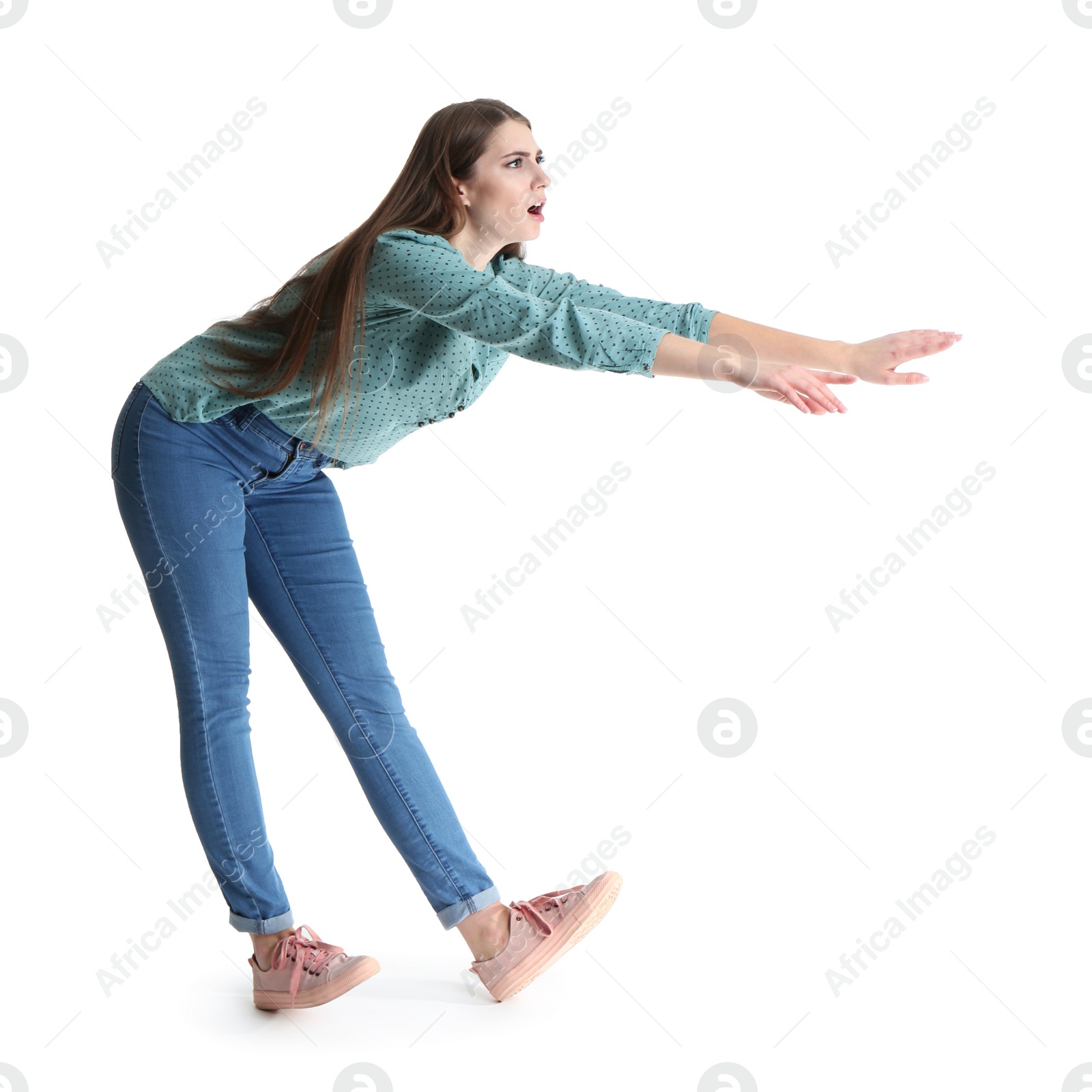 Photo of Young woman attracted to magnet on white background