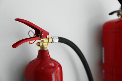 Photo of Fire extinguisher on white background, closeup view