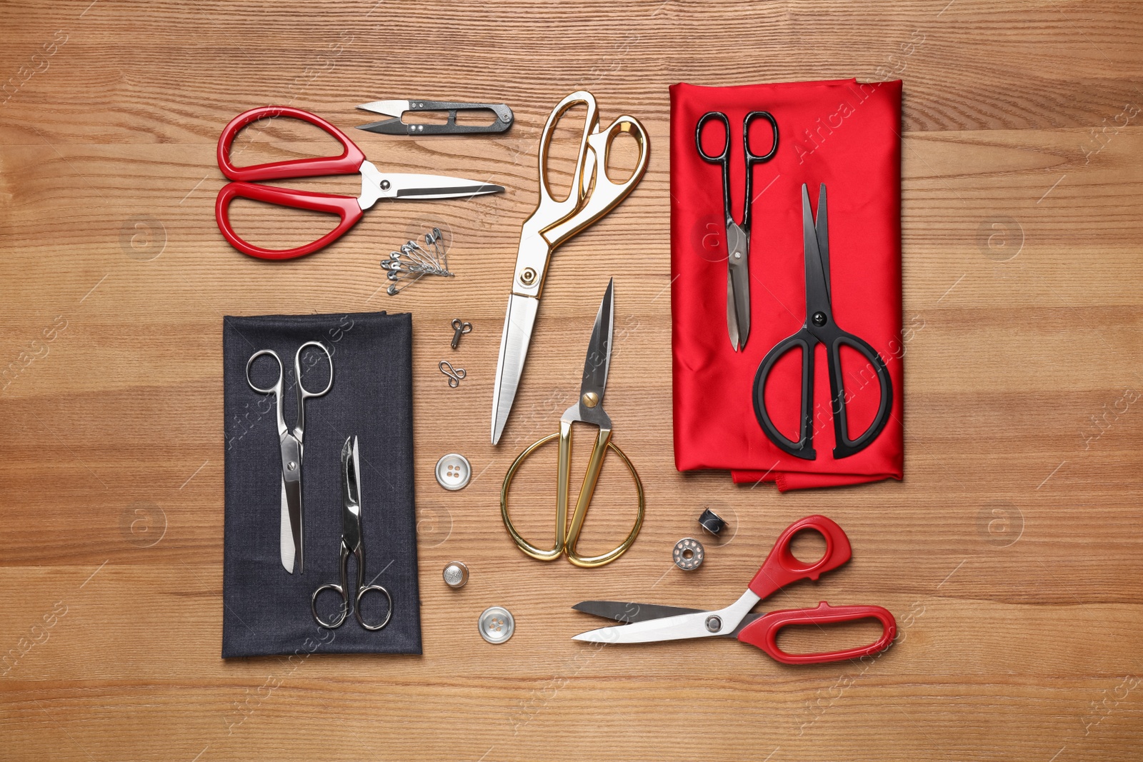 Photo of Flat lay composition with different sewing accessories on wooden background