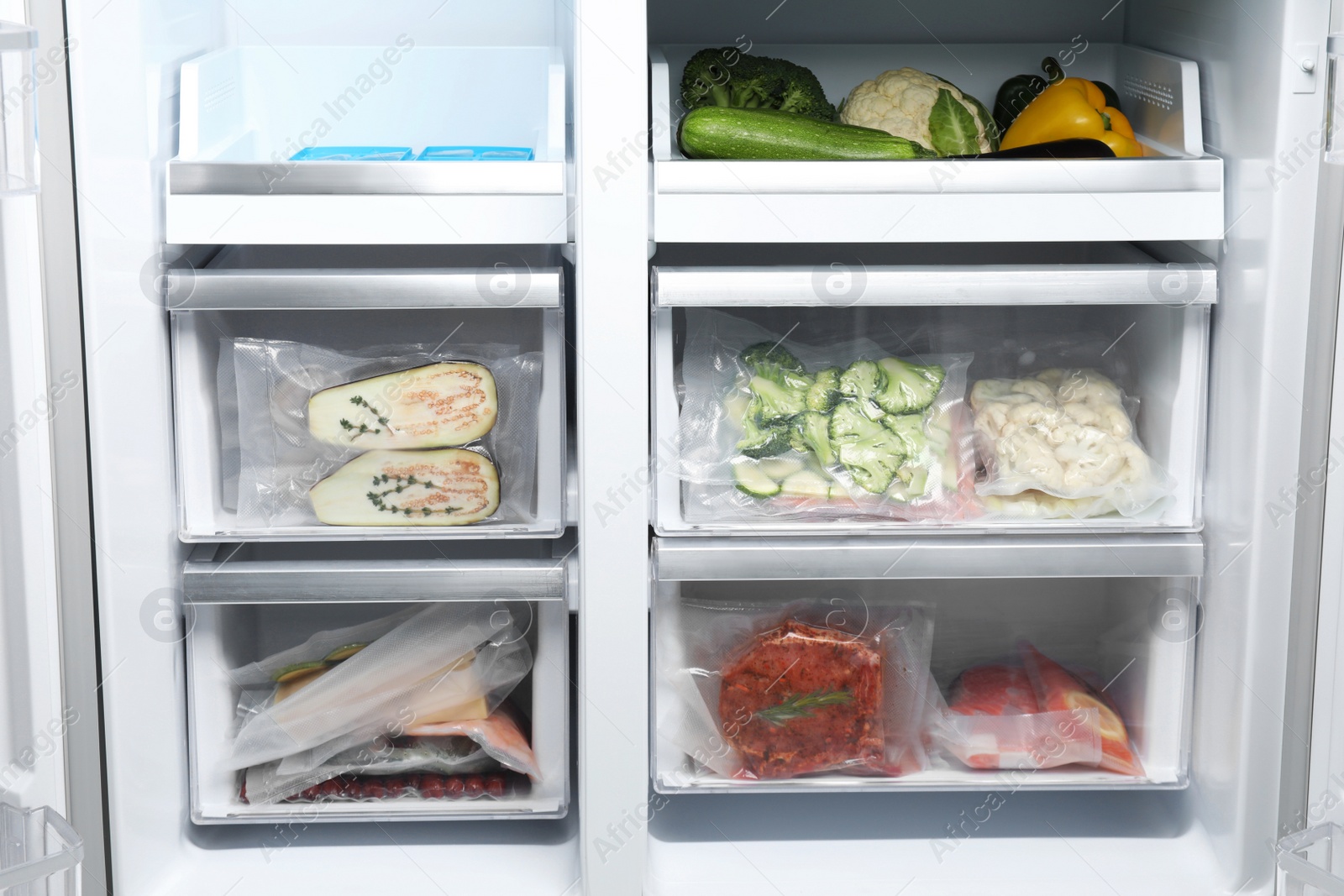 Photo of Vacuum bags with different products in fridge. Food storage