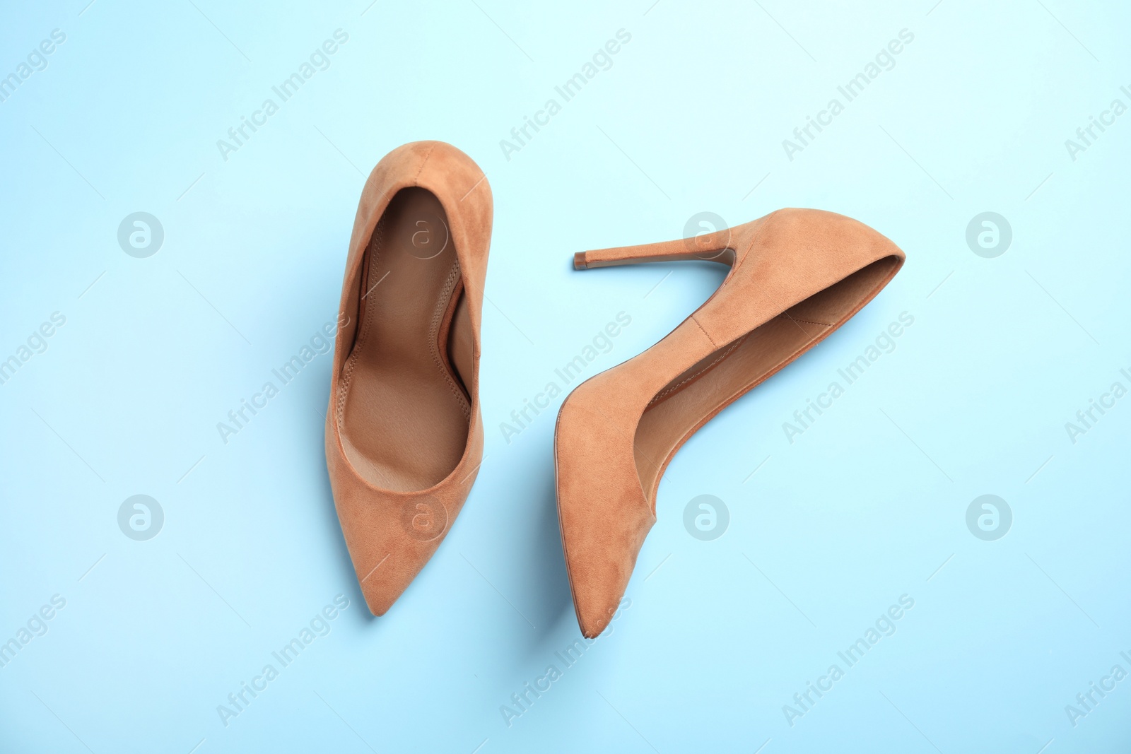 Photo of Pair of beautiful shoes on color background, top view