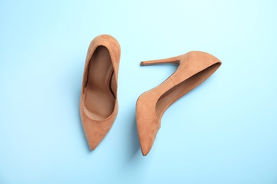 Photo of Pair of beautiful shoes on color background, top view