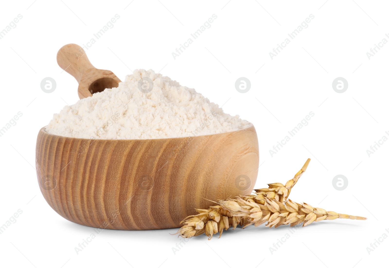 Photo of Bowl with scoop and organic wheat flour isolated on white