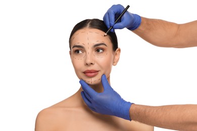 Photo of Doctor with pencil preparing patient for cosmetic surgery operation on white background