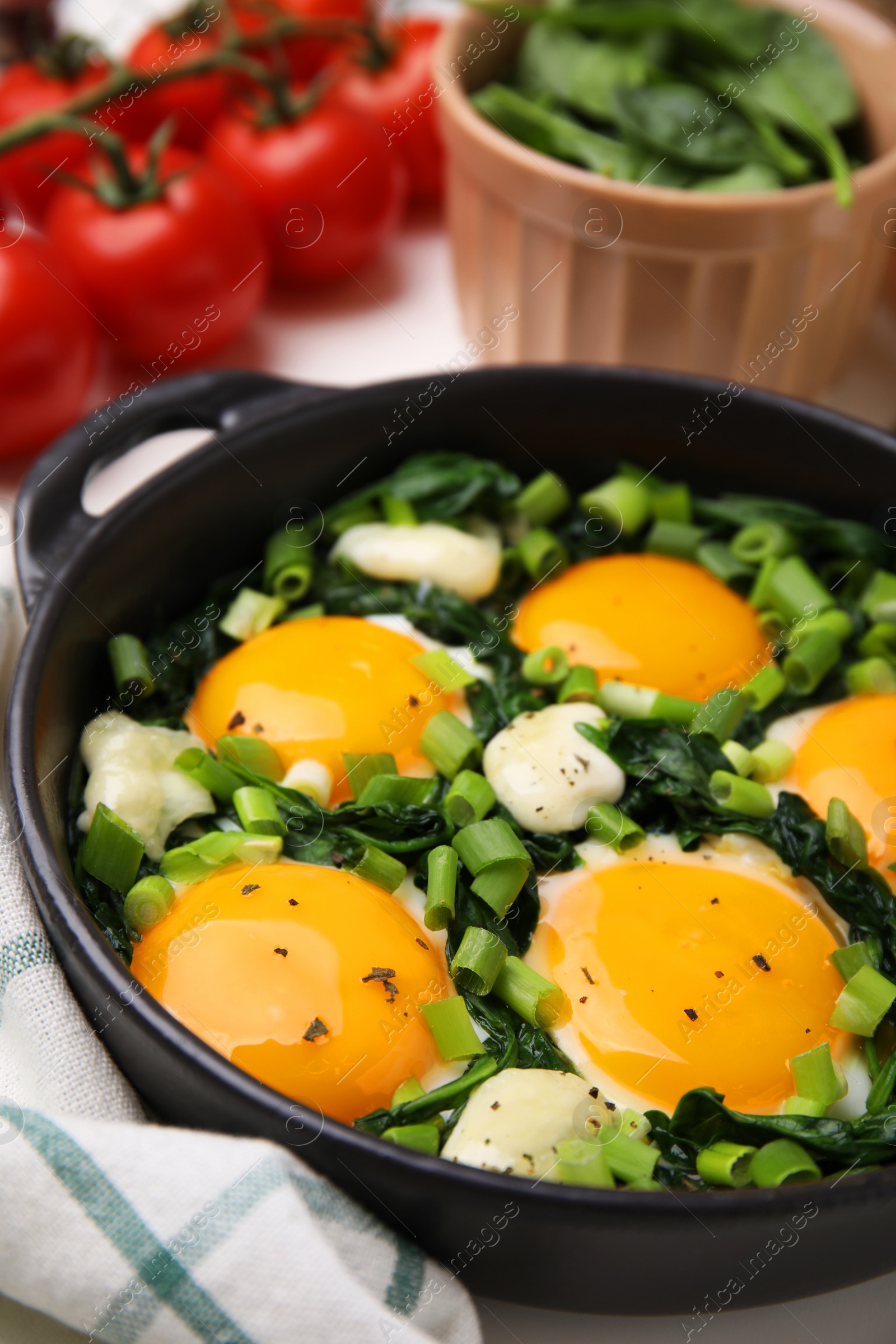 Photo of Tasty green Shakshouka served on white table, closeup