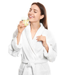 Young woman drinking lemon water on white background