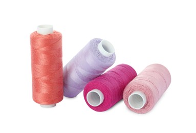 Photo of Many different colorful sewing threads on white background