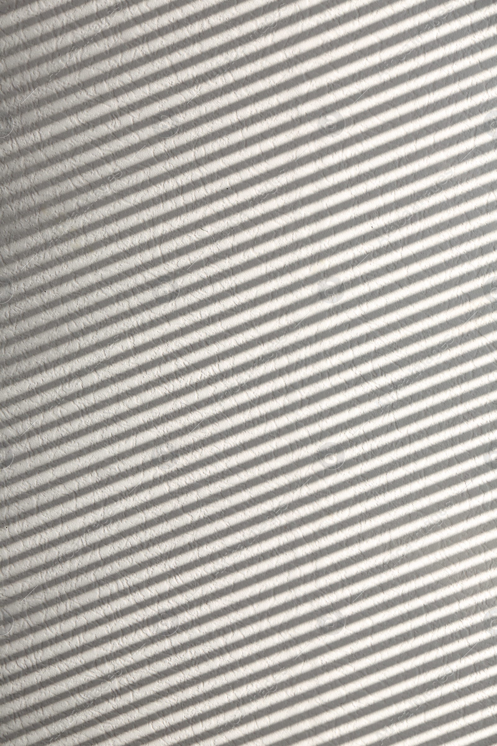 Photo of Light and shadow from window on white wall, space for text