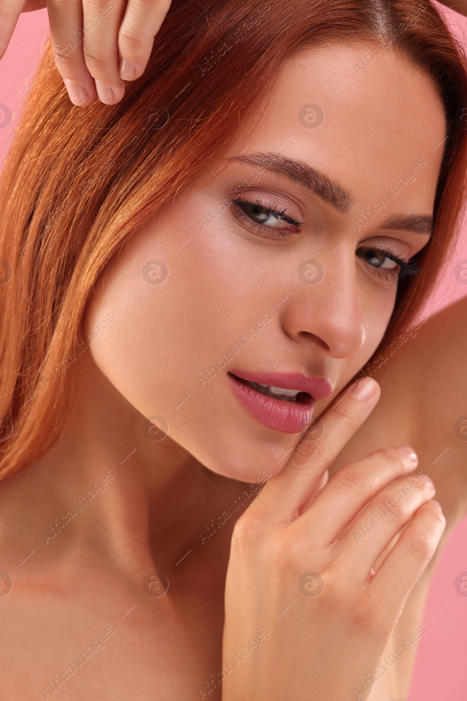 Photo of Portrait of beautiful young woman on pink background, closeup