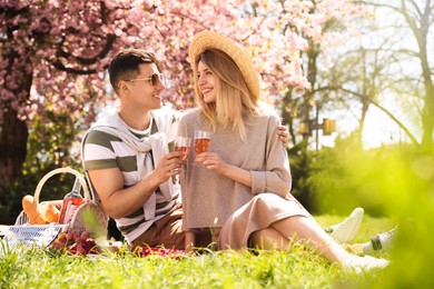 Photo of Happy couple having picnic in park on sunny day