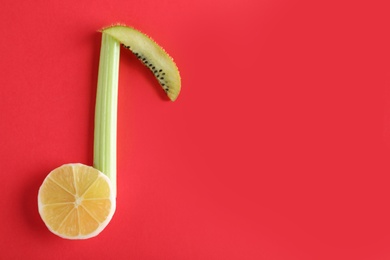 Photo of Musical note made of vegetables and fruits on color background, top view. Space for text