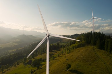 Image of Modern wind turbines in mountains. Alternative energy source