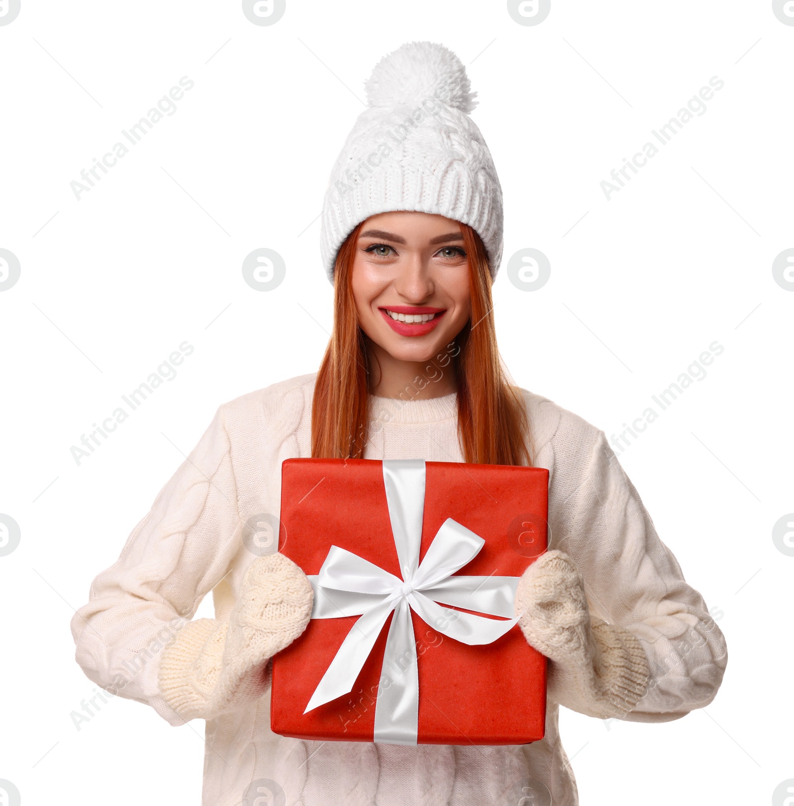 Photo of Young woman in hat and sweater with Christmas gift on white background