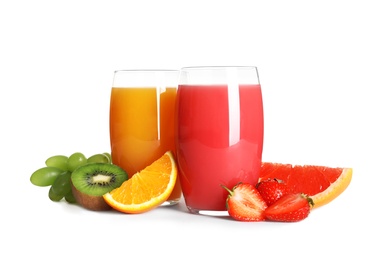 Glasses with different juices and fresh fruits on white background