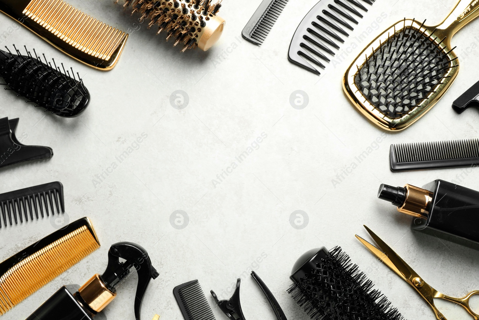 Photo of Frame of hairdressing tools on light background, flat lay. Space for text