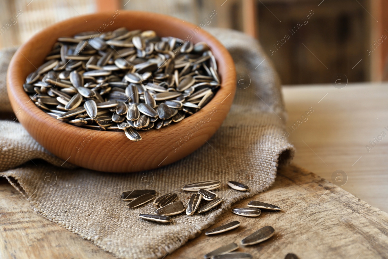 Photo of Organic sunflower seeds on wooden table, closeup