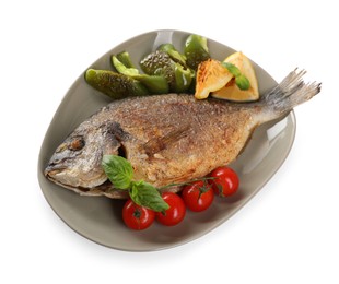 Delicious roasted dorado fish, vegetables, and lemon isolated on white, top view