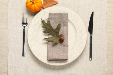 Photo of Autumn table setting, pumpkin and dry leaves, flat lay