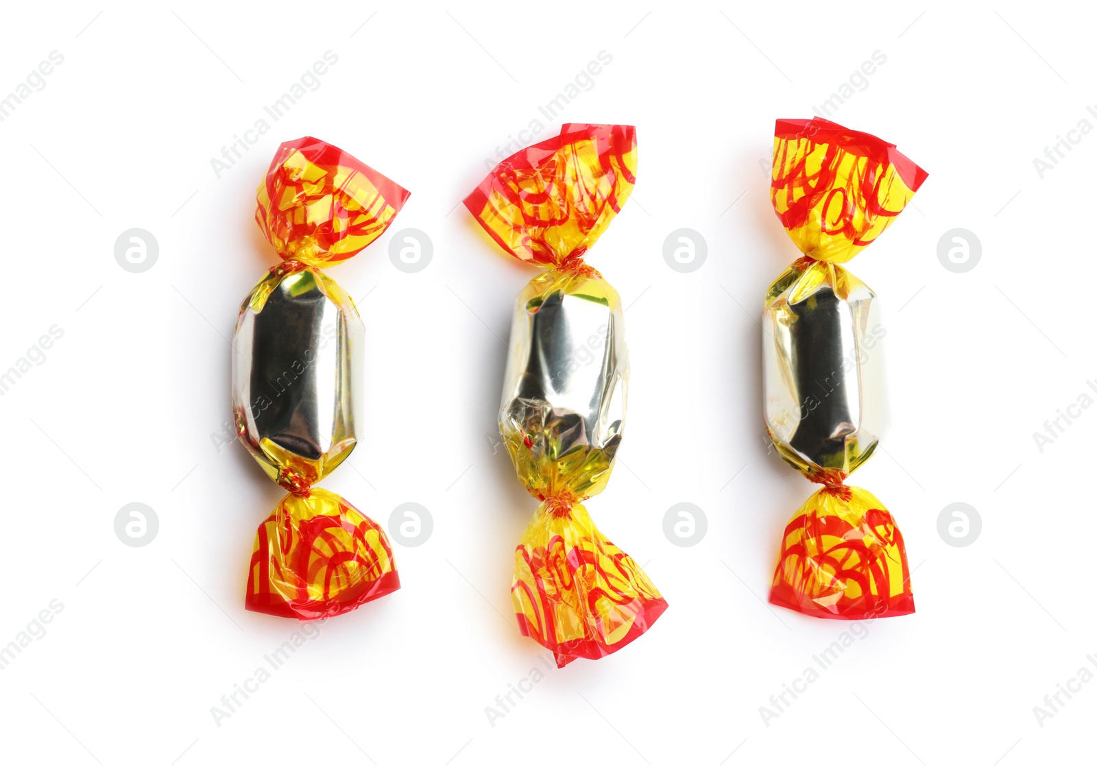 Photo of Delicious candies wrapped in foil on white background, top view