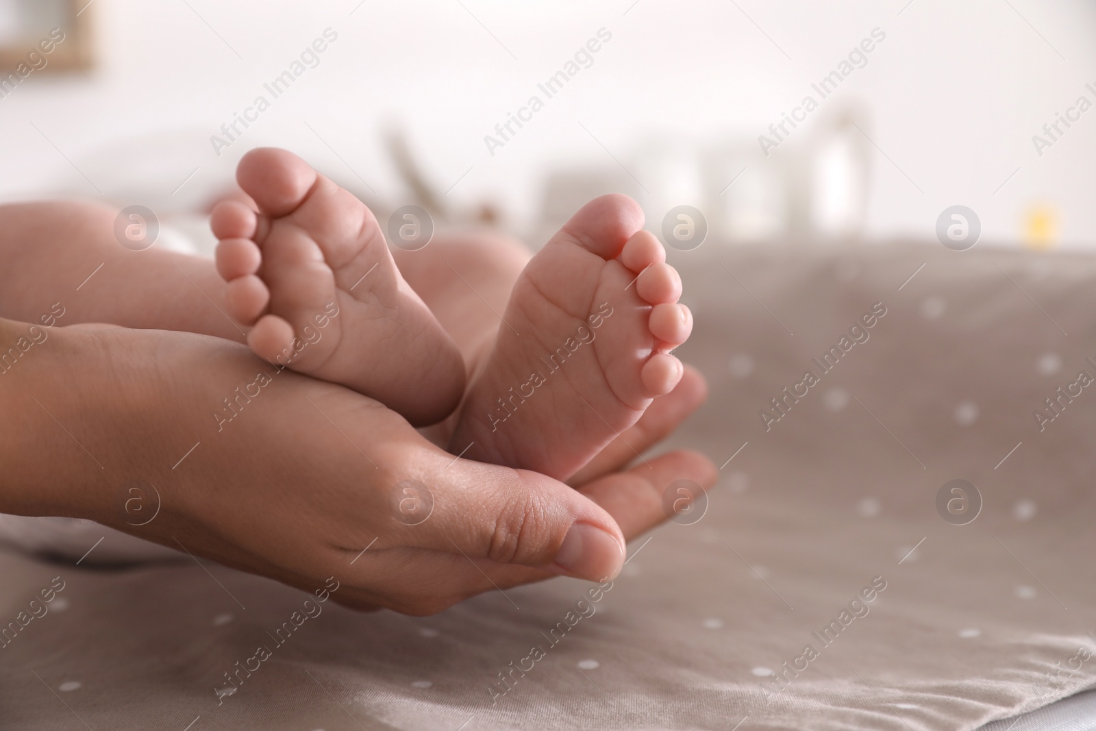 Photo of Mother and her little baby on bed, closeup