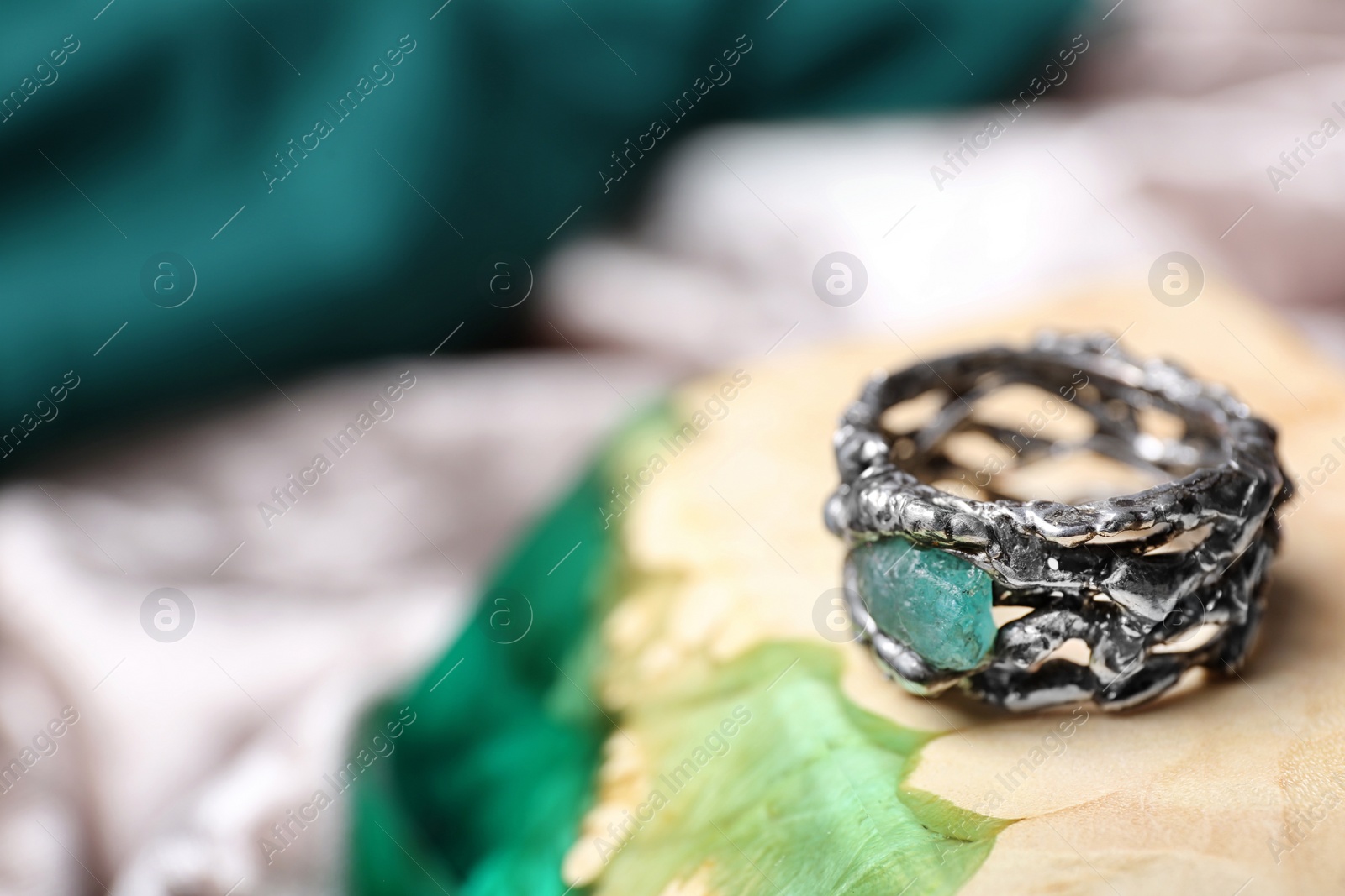 Photo of Beautiful silver ring with apatite gemstone on color background. Space for text