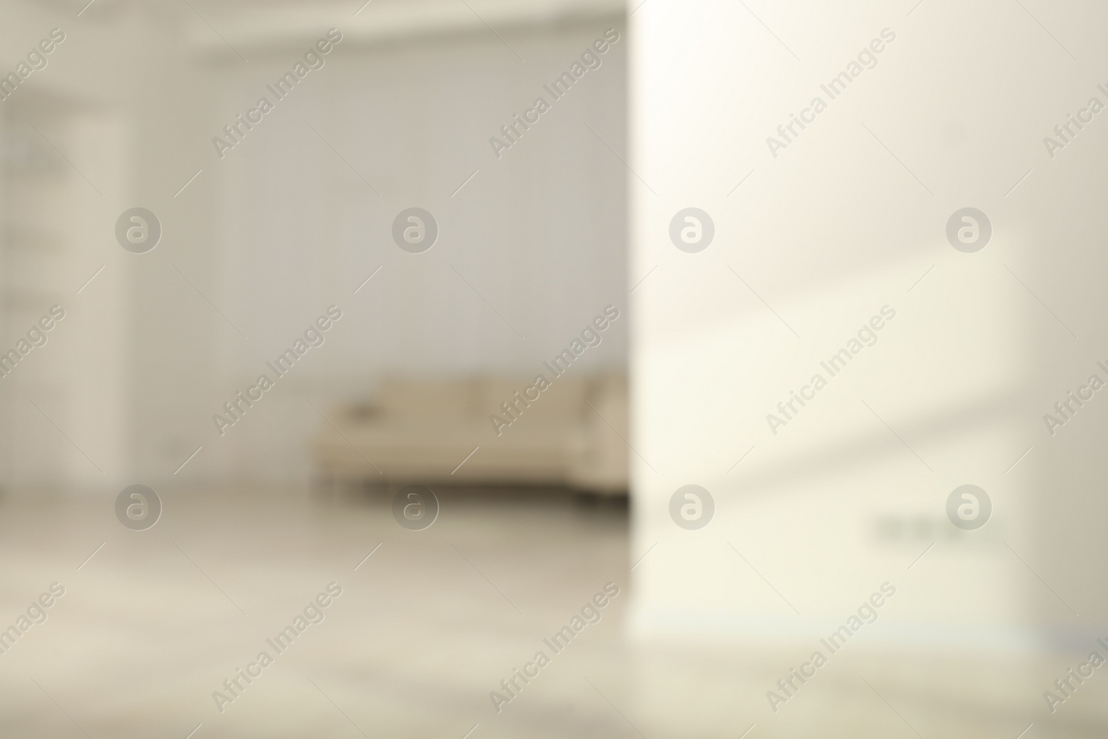 Photo of Blurred view of room with sofa and shadows on wall