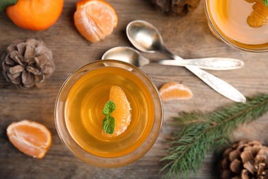 Photo of Delicious tangerine jelly on wooden table, flat lay