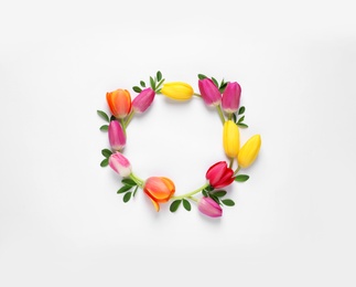 Photo of Frame made of beautiful spring flowers on white background, top view. Space for text