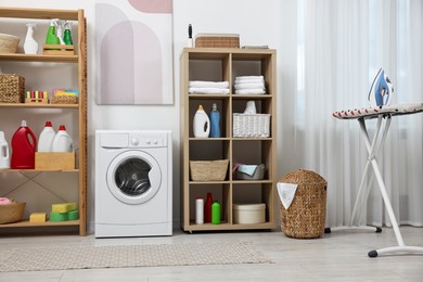 Photo of Laundry room interior with washing machine and furniture