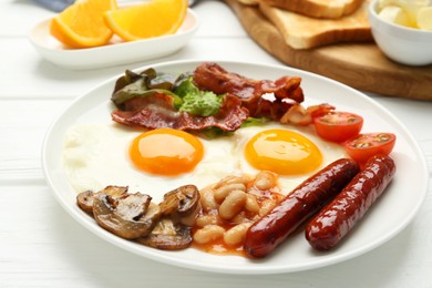 Photo of Delicious breakfast with sunny side up eggs on white wooden table, closeup