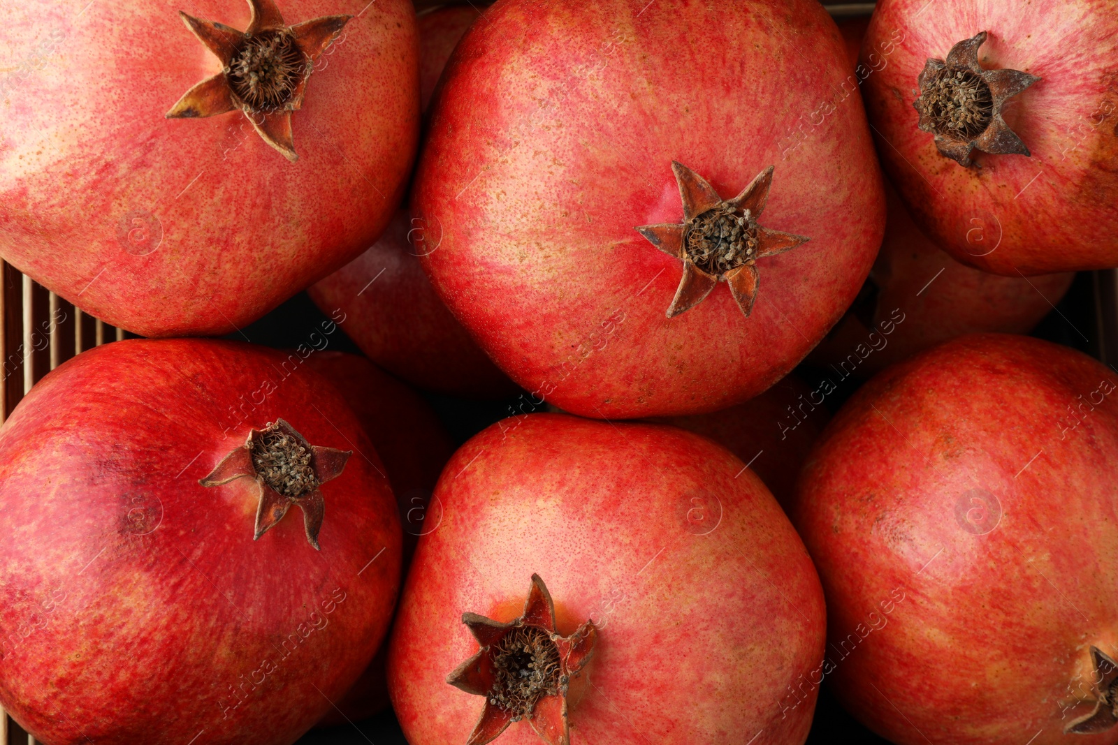 Photo of Fresh ripe pomegranates as background, top view