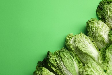Photo of Fresh ripe Chinese cabbages on light green background, flat lay. Space for text