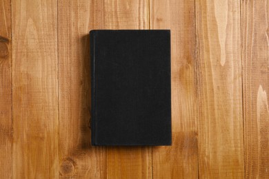 Photo of Old hardcover book on wooden table, top view