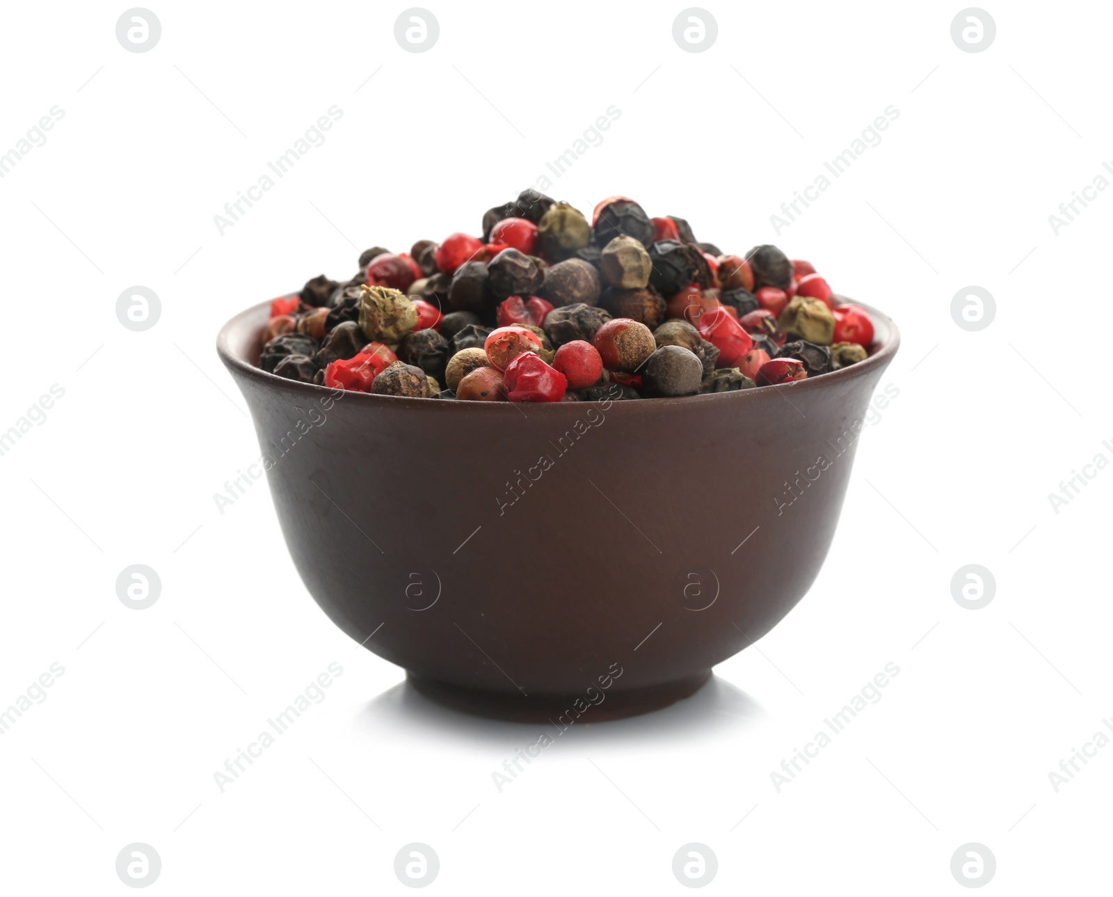 Photo of Bowl with different pepper grains on white background