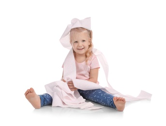 Cute little girl playing with toilet paper on white background