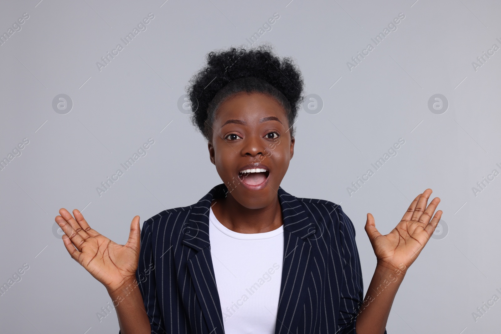 Photo of Portrait of emotional young woman on light grey background