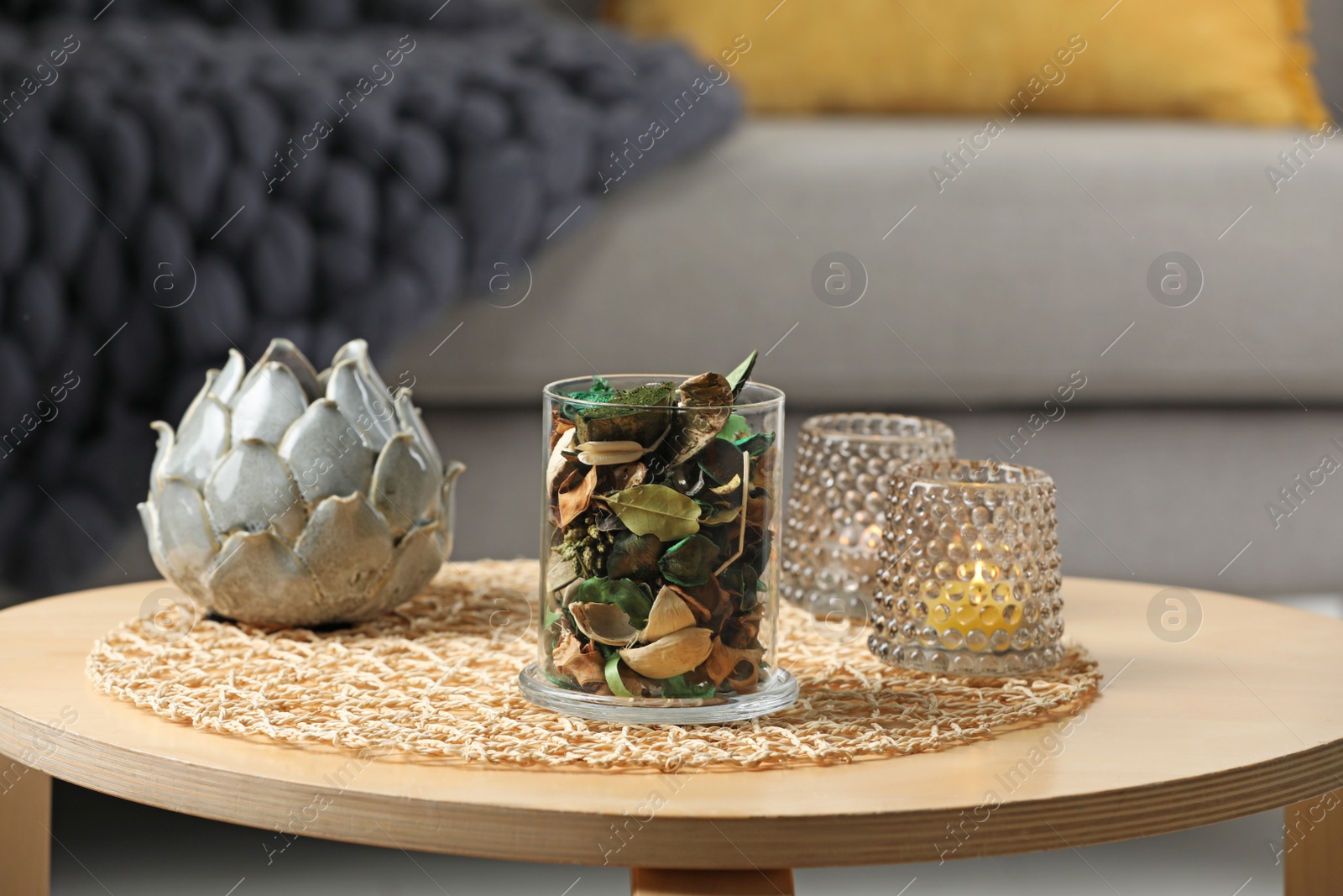 Photo of Glass jar with aromatic potpourri of dried flowers and different decor on wooden table indoors