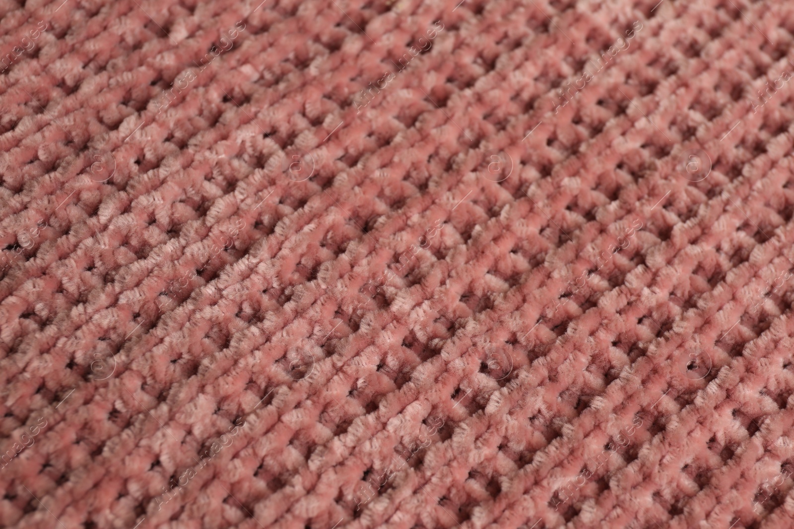 Photo of Beautiful pink knitted fabric as background, closeup