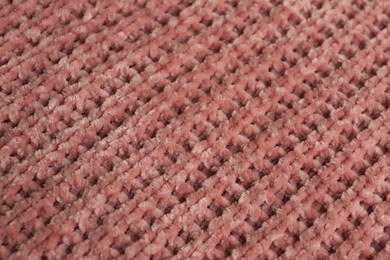 Photo of Beautiful pink knitted fabric as background, closeup