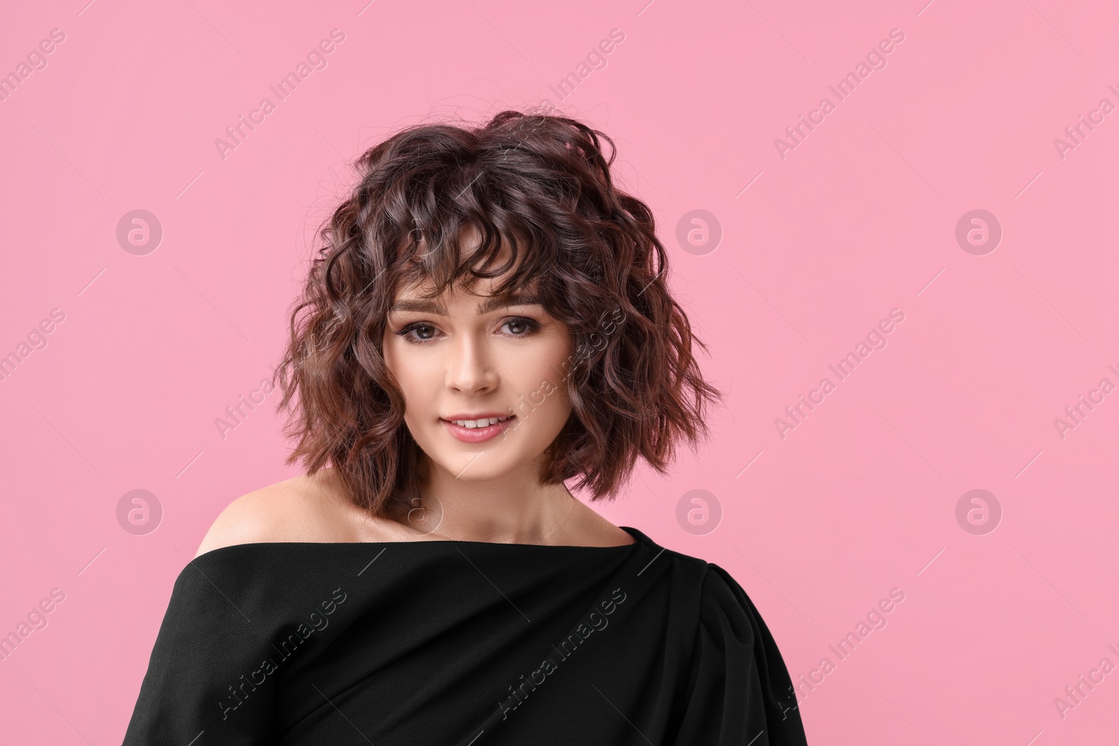 Photo of Portrait of beautiful young woman with wavy hairstyle on pink background. Space for text