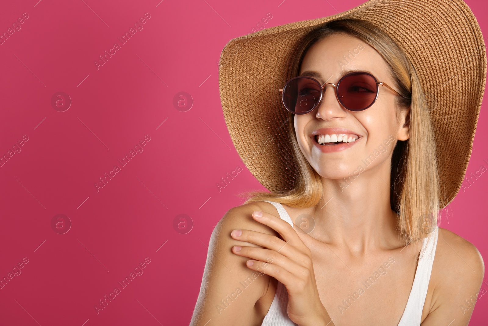 Photo of Beautiful woman in stylish sunglasses on pink background. Space for text