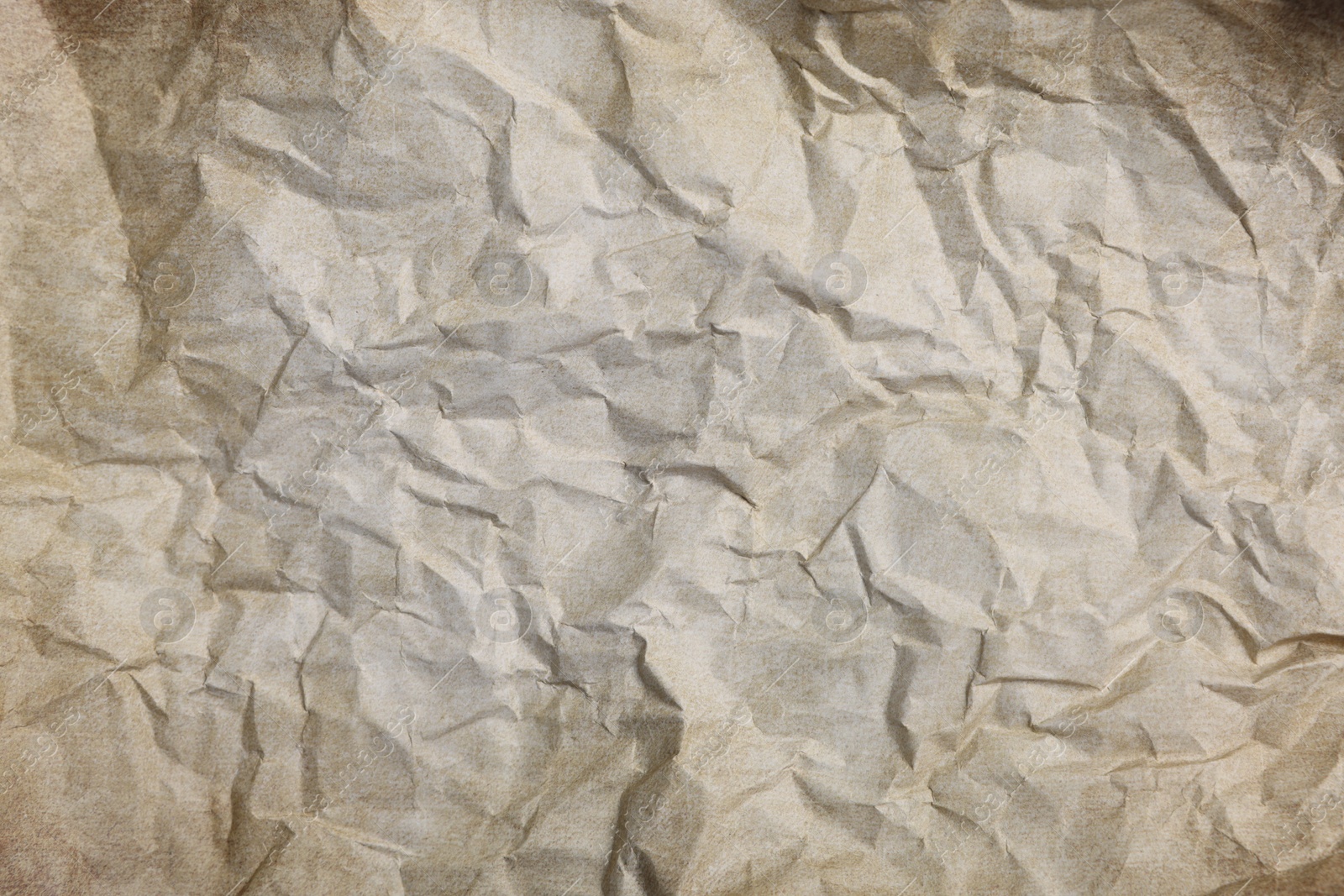 Photo of Texture of crumpled parchment paper as background, top view