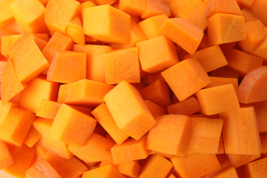 Photo of Cubes of fresh ripe carrots as background, top view
