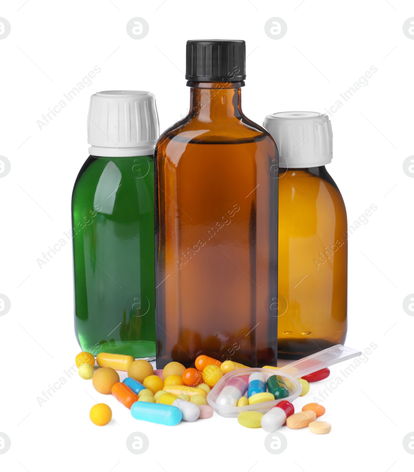 Photo of Bottles of syrups with pills on white background. Cough and cold medicine