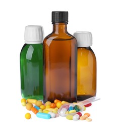 Photo of Bottles of syrups with pills on white background. Cough and cold medicine