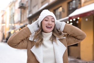 Portrait of smiling woman on city street in winter