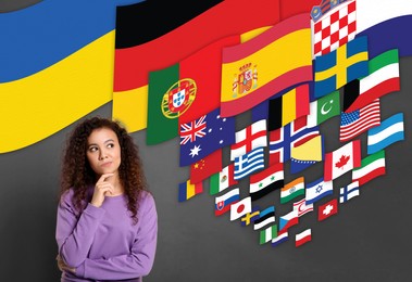 Image of Portrait of interpreter and flags of different countries on grey background