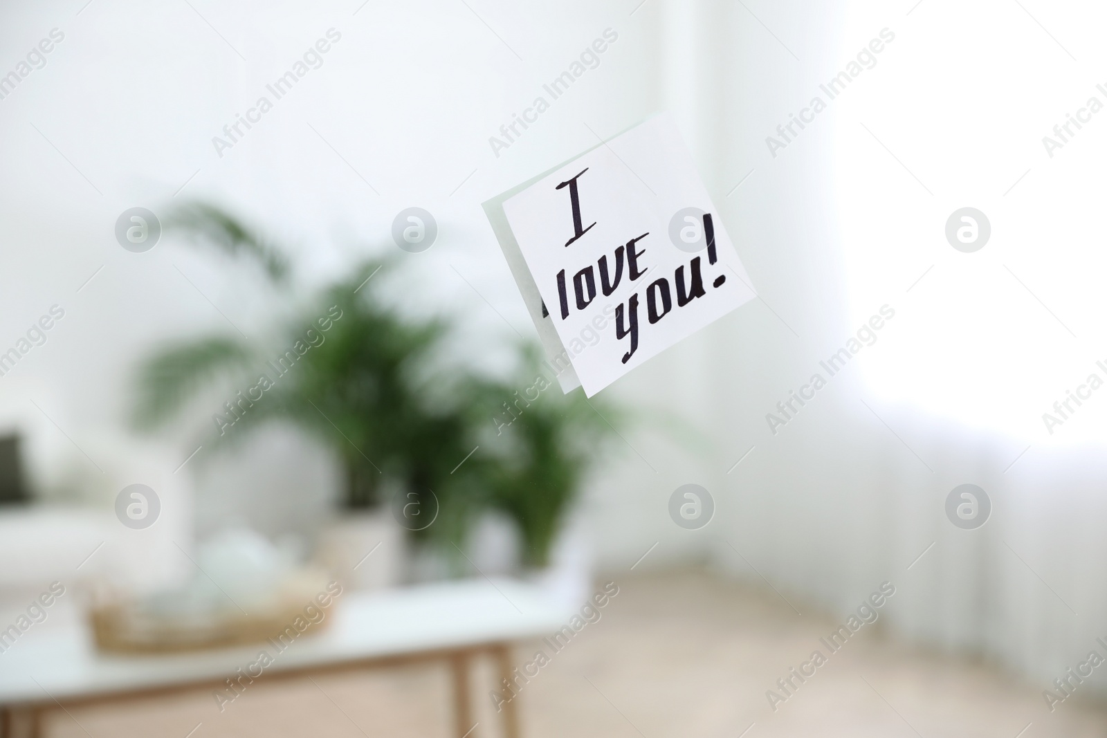 Photo of Paper note with handwritten words I Love You on mirror indoors