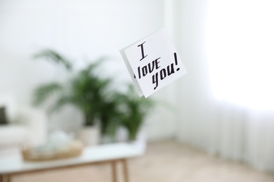 Photo of Paper note with handwritten words I Love You on mirror indoors